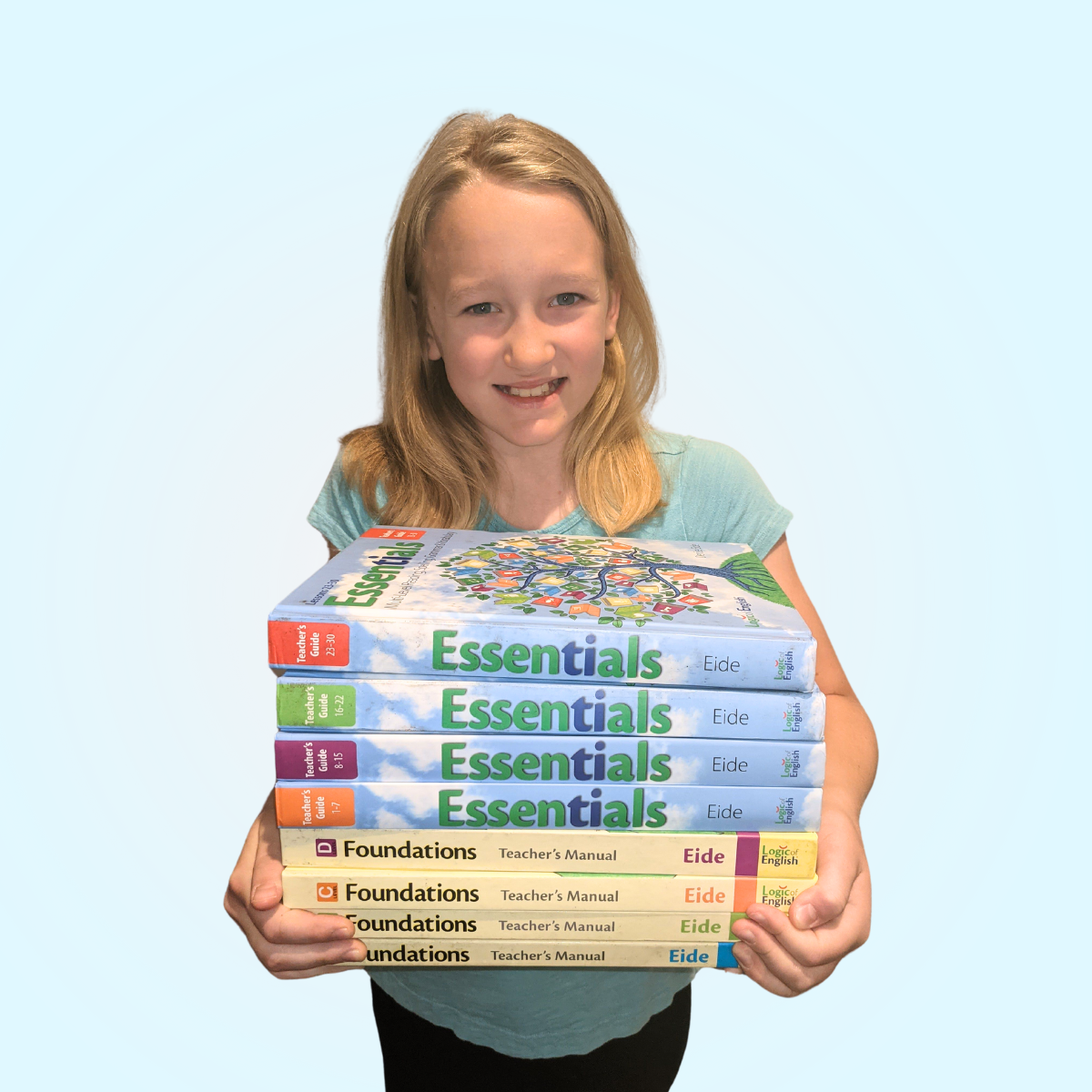 student holding Essentials and Foundations books