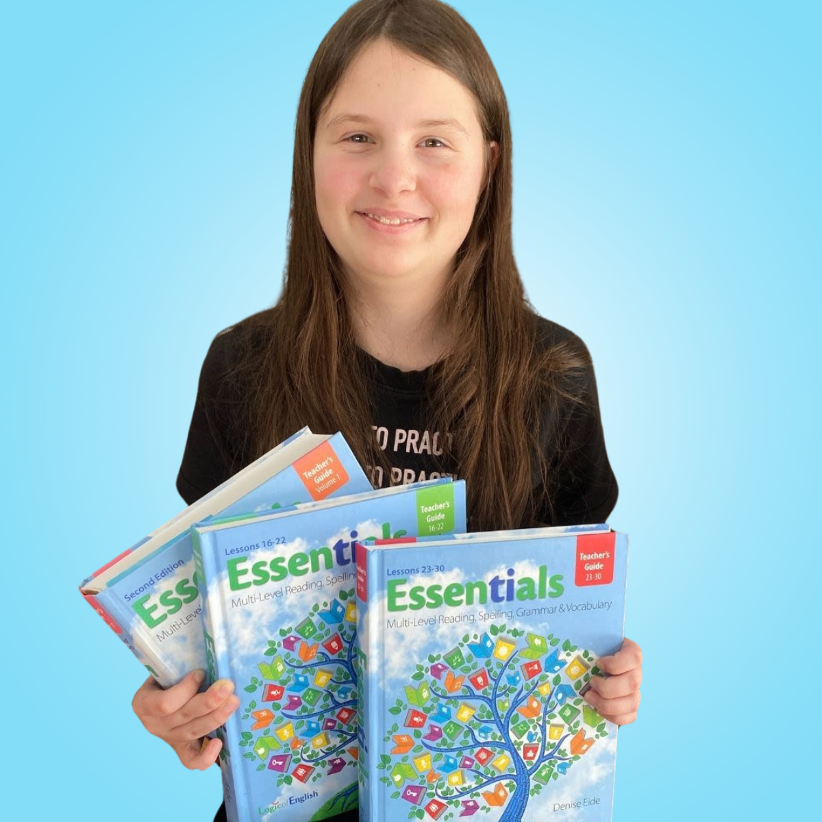 student holding Essentials books