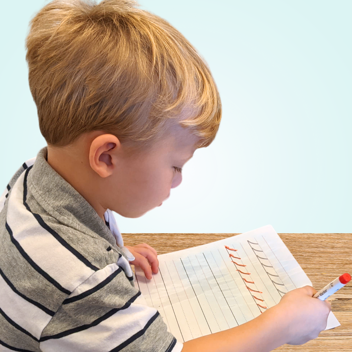 child practicing strokes on whiteboard