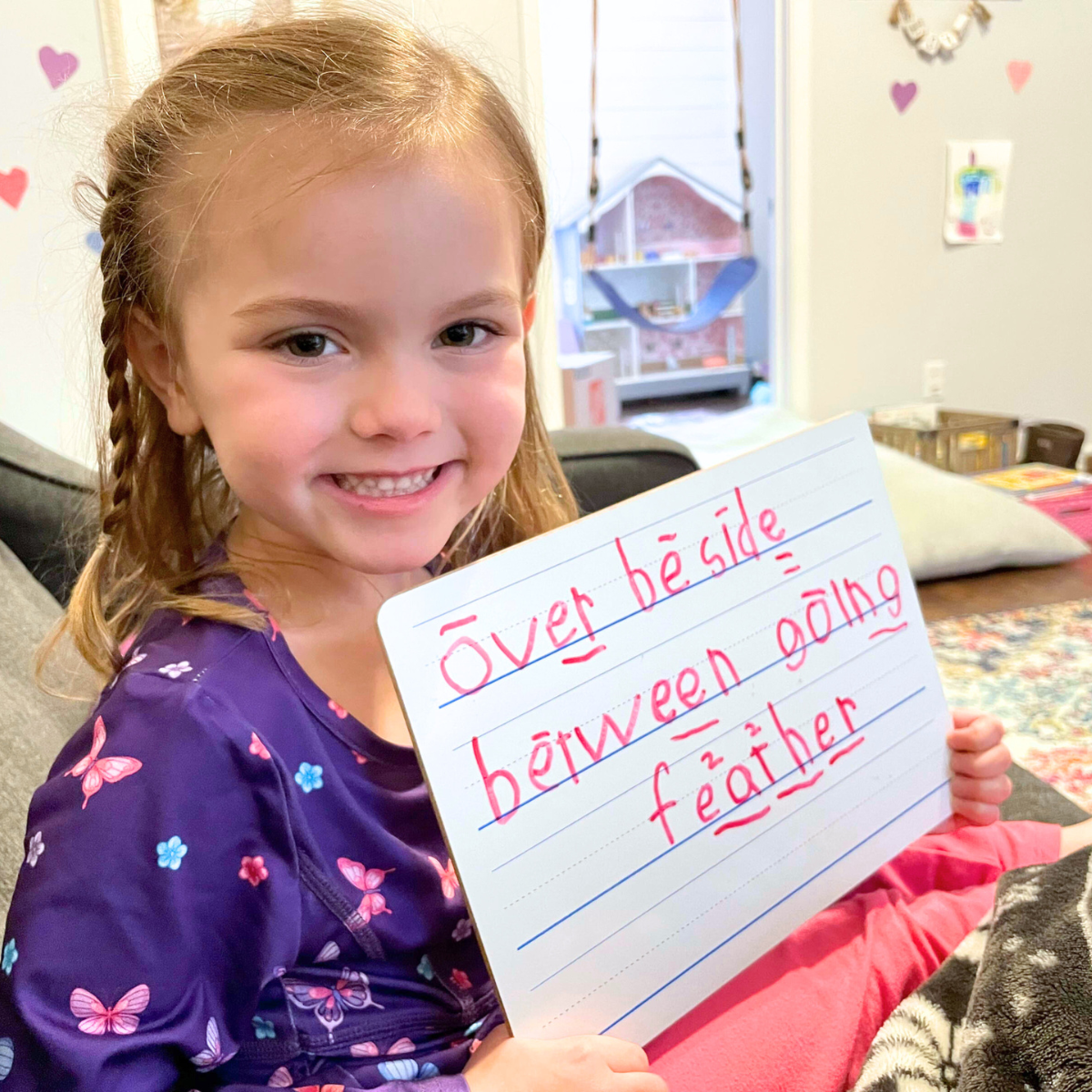 student holding whiteboard after spelling analysis