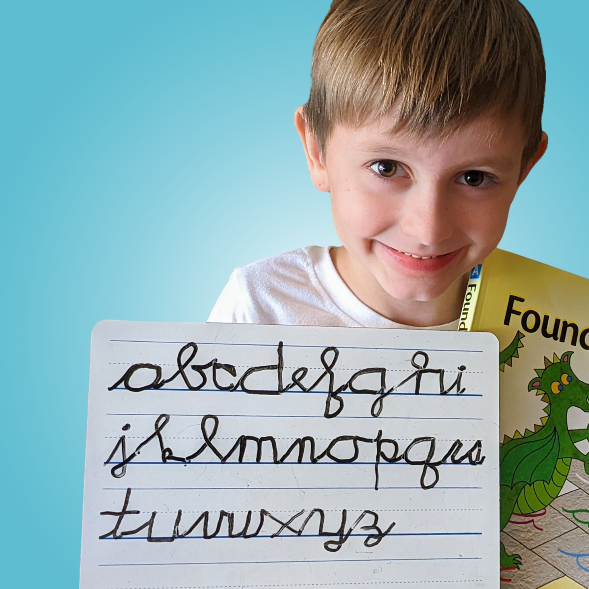 child holding whiteboard with cursive alphabet