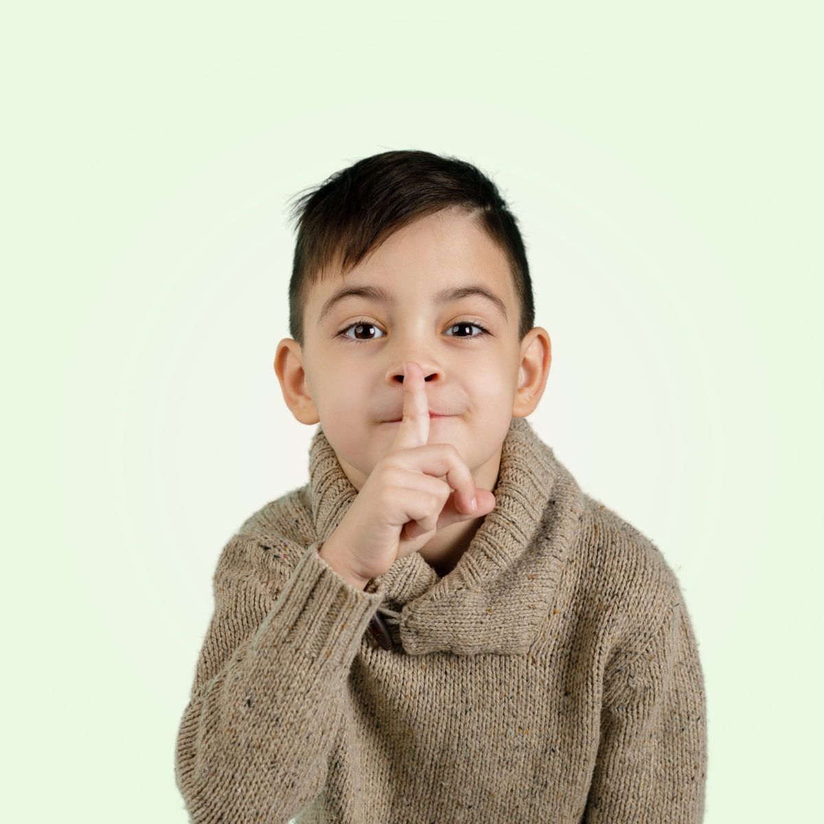kid with finger to lips