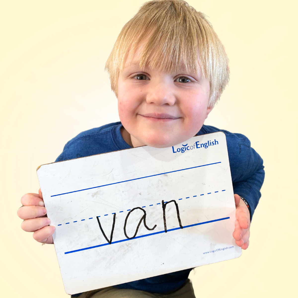 student holding whiteboard with van written on it