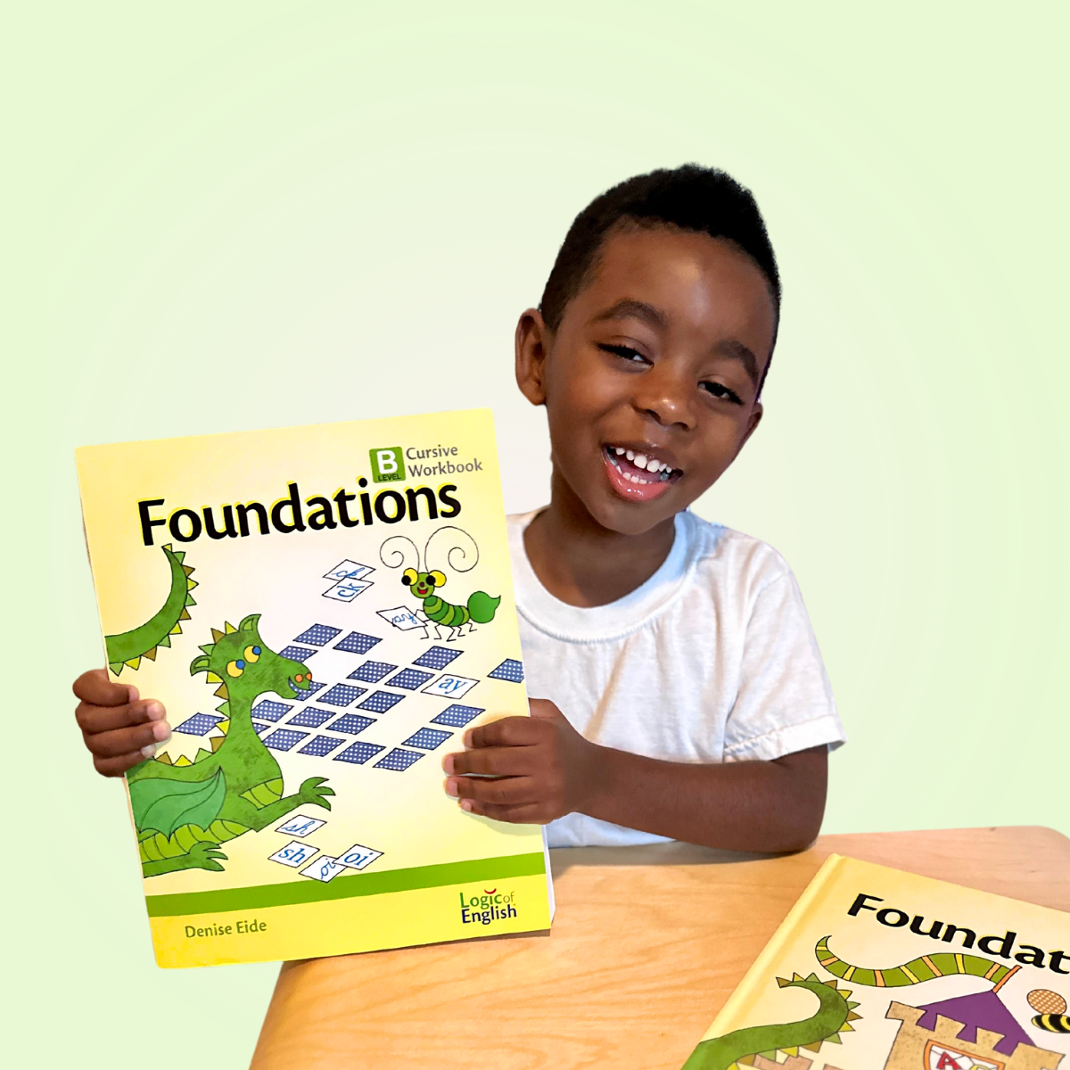 boy holding Foundations workbook