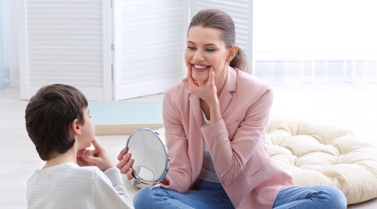 woman and child practicing sounds in mirror