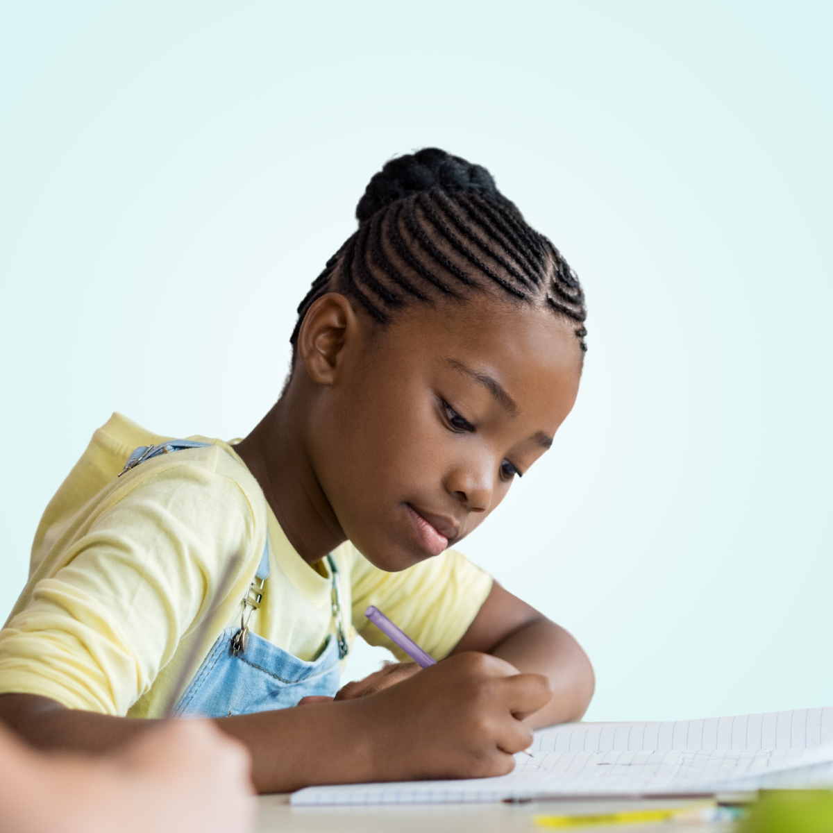 child writing on paper