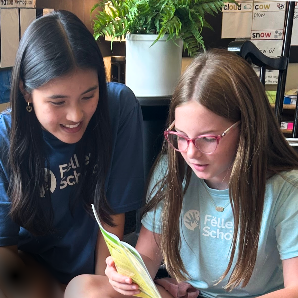 student reading controlled reader with adult