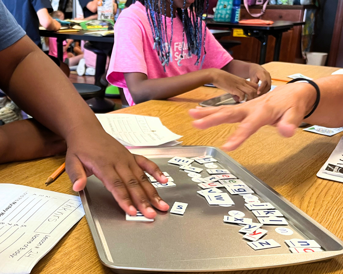 students using phonogram game tiles