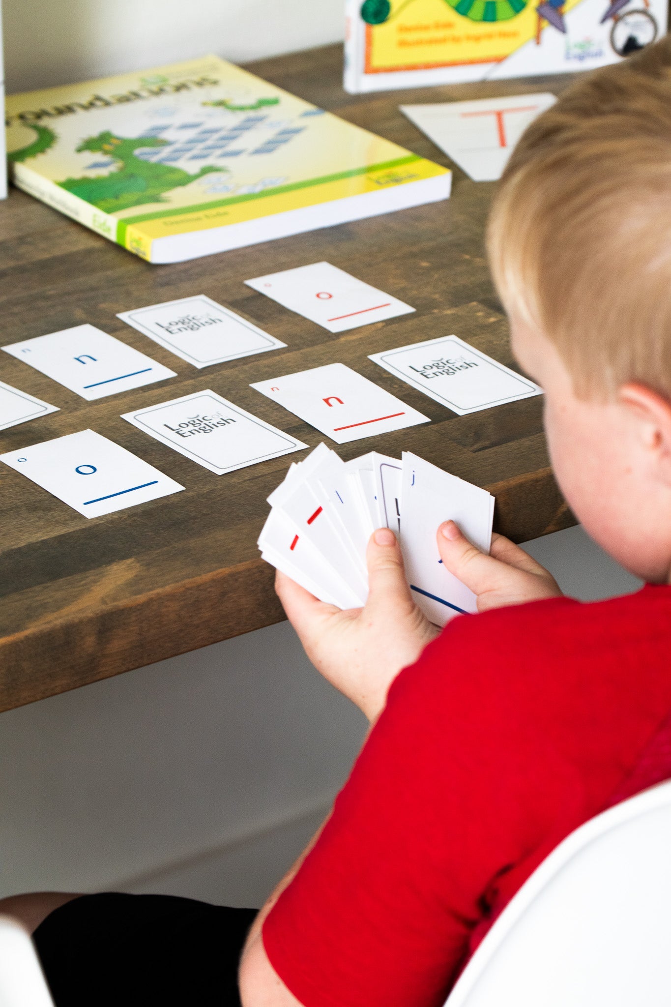 student playing with phonogram game cards